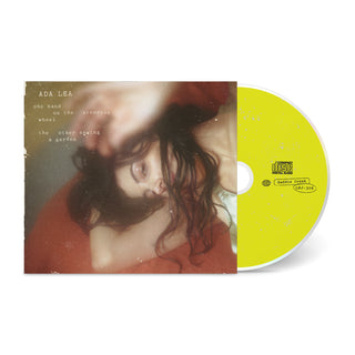 one hand on the steering wheel the other sewing a garden