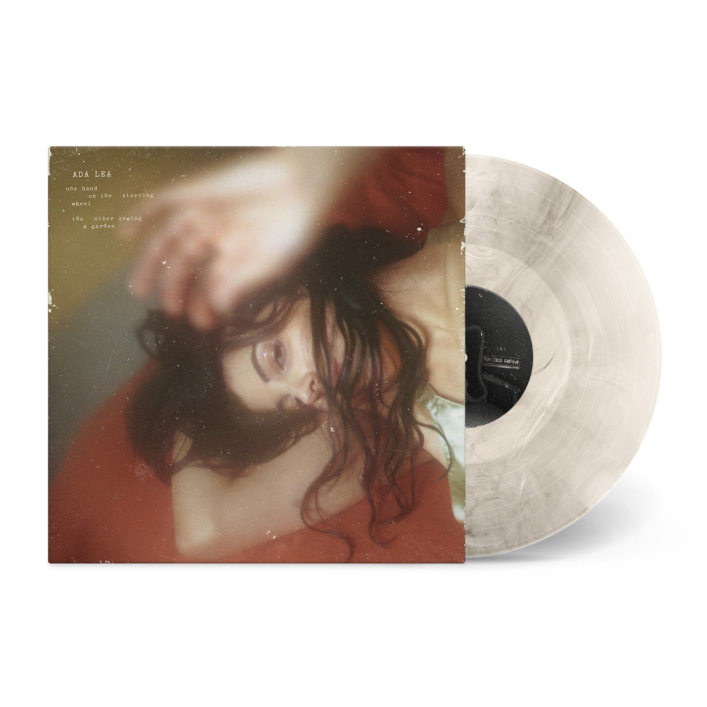 one hand on the steering wheel the other sewing a garden